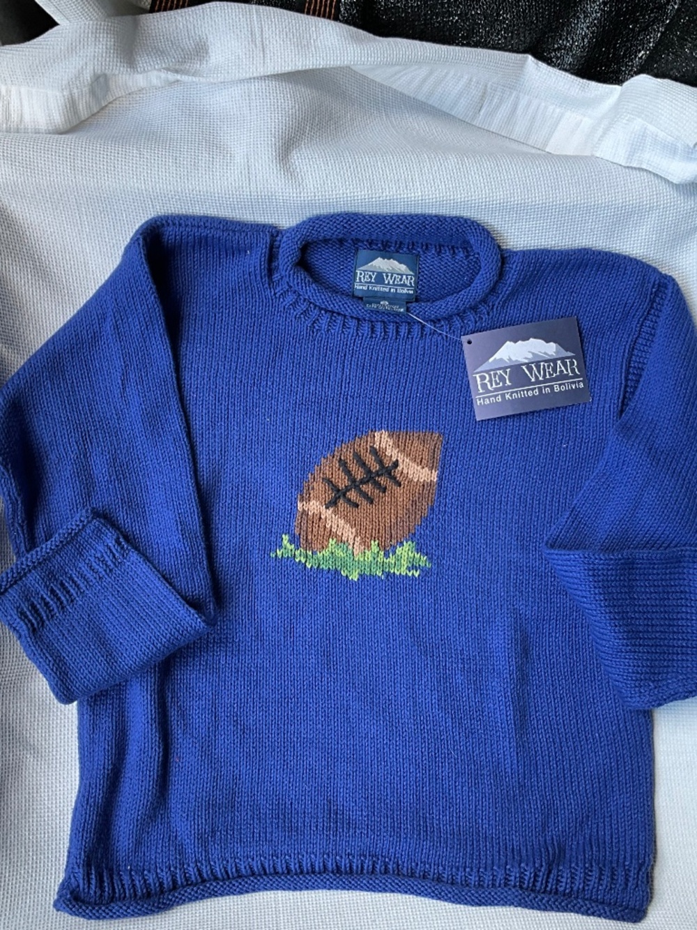 Hand knit sweater from Bolivia. Size S. Cotton- rolled neck. Football theme